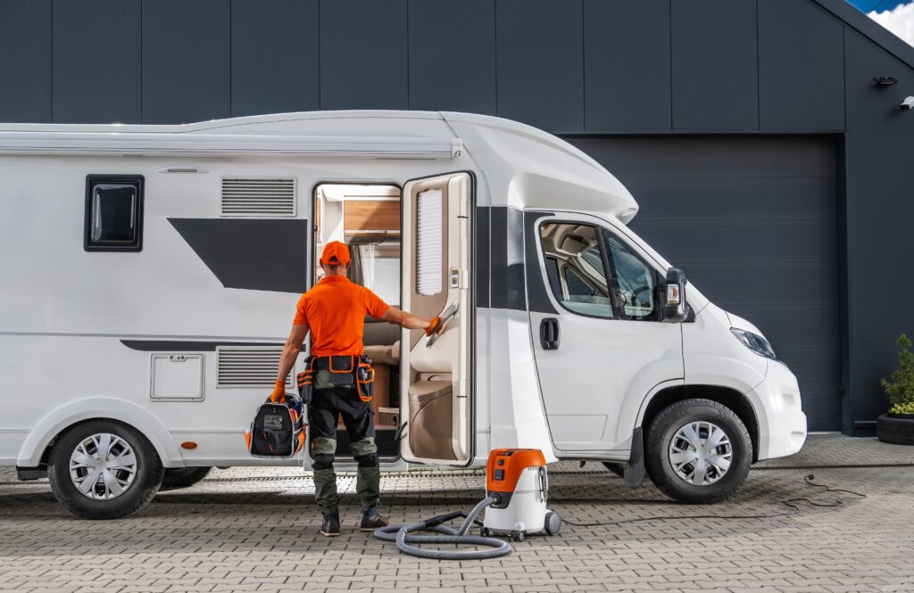 man performing maintenance services on a motorhome